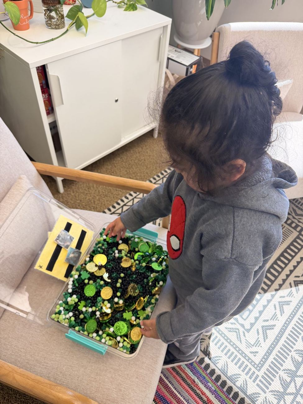 A child exploring a sensory bin
